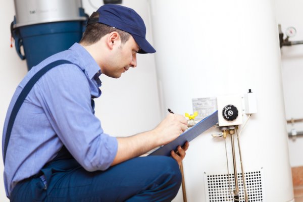 Technician inspecting a residential hot water system