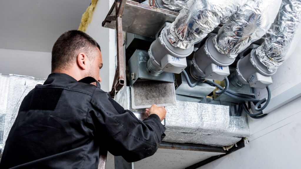 Technician cleaning residential ductwork