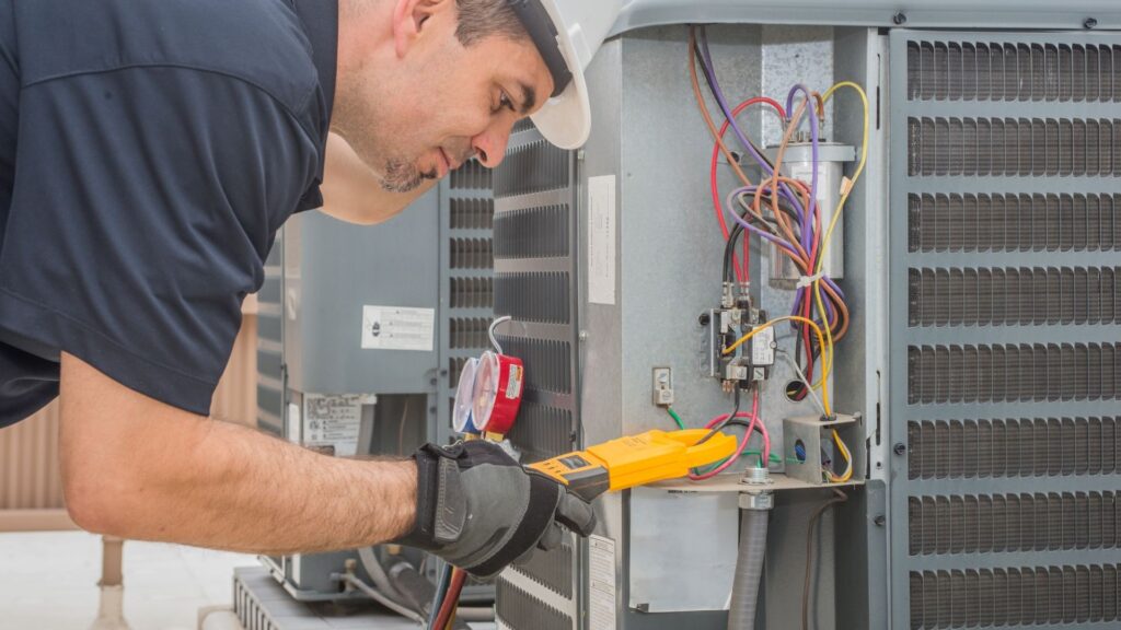 Technician testing an outdoor air conditioner