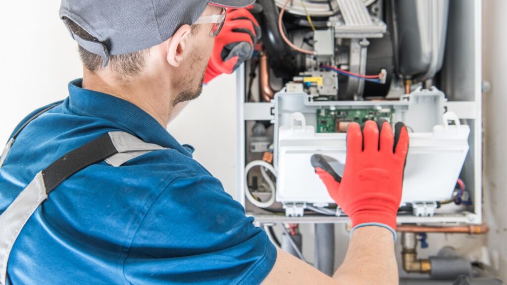 Technician servicing a residential furnace