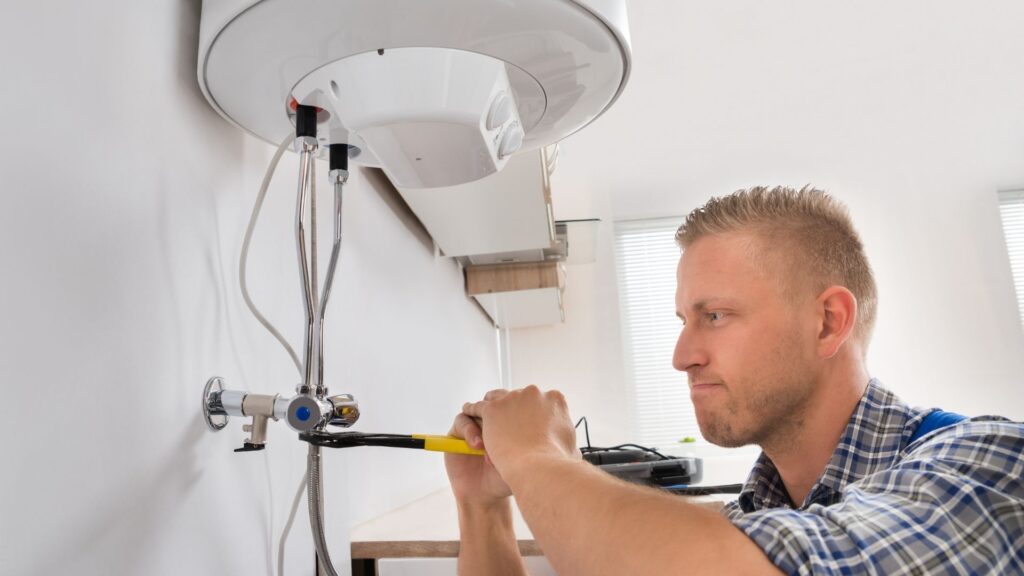 Technician servicing a residential hot-water tank