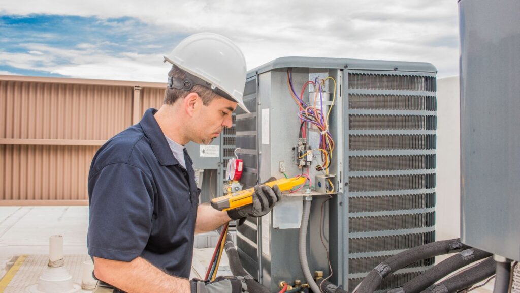 Technician testing an outdoor air-conditioning unit