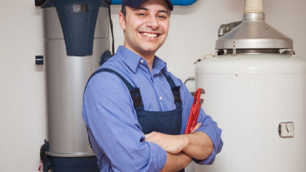 Technician beside a residential hot-water tank