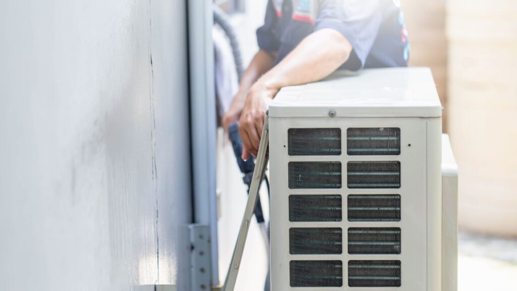 Technician installing an outdoor air-conditioning unit
