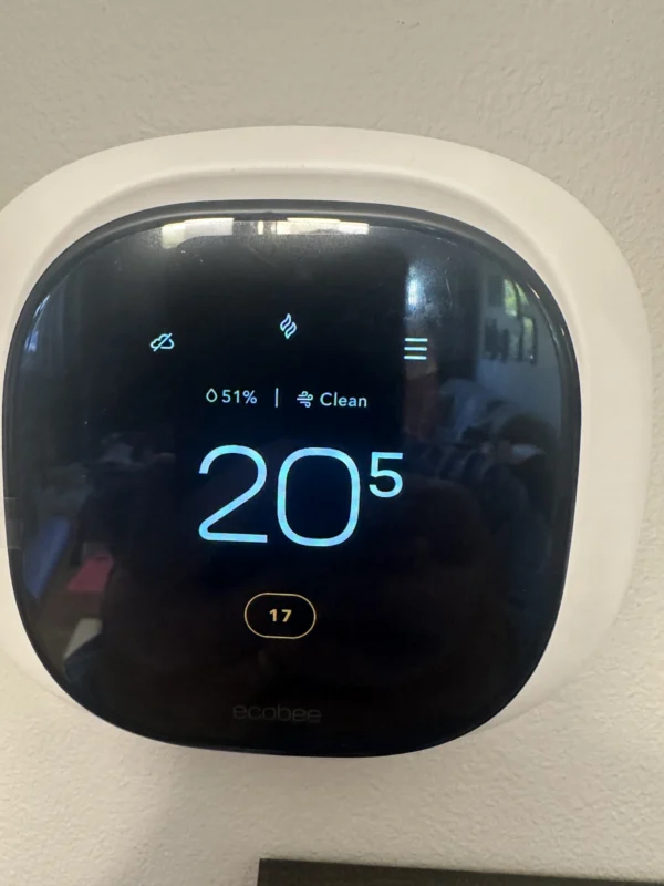 Smart thermostat displaying indoor temperature