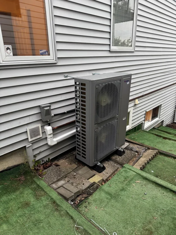 Outdoor heat-pump unit installed beside a home