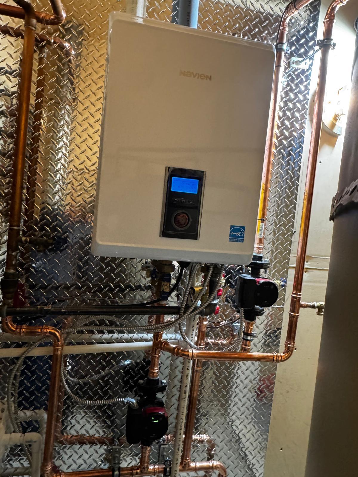 Wall-mounted tankless water heater and hydronic piping