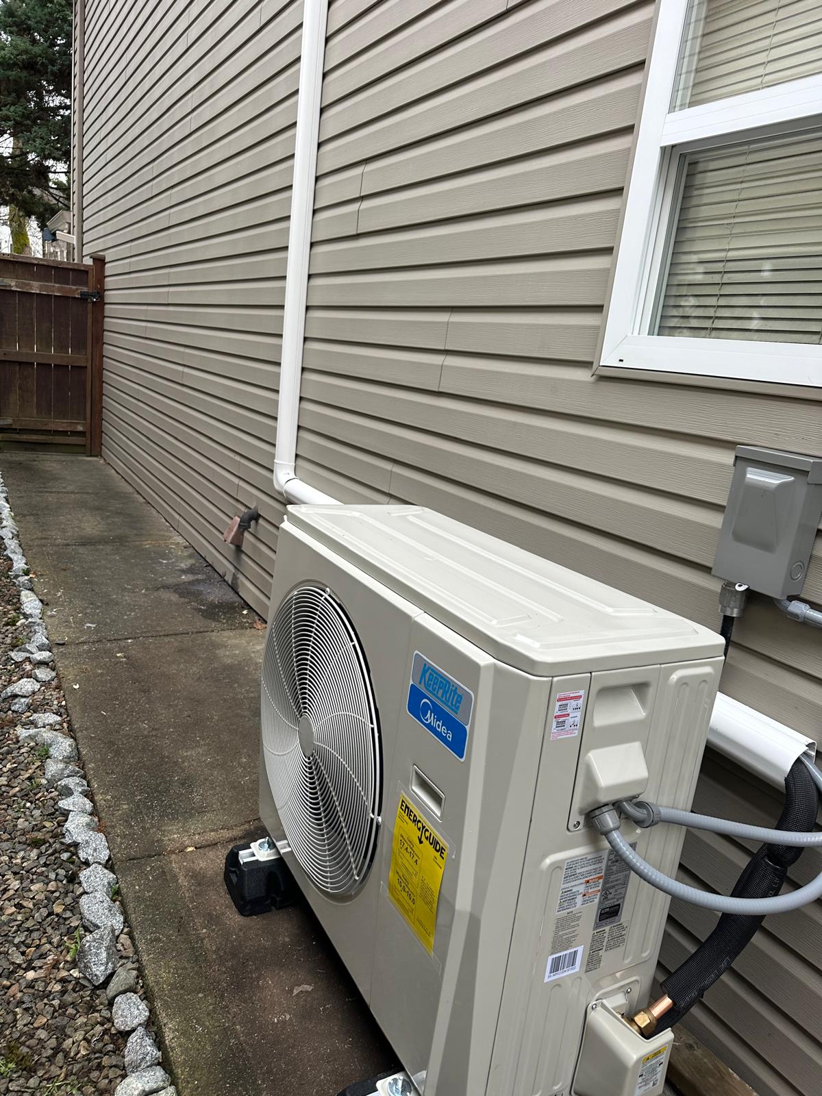 Outdoor heat-pump unit installed beside a home