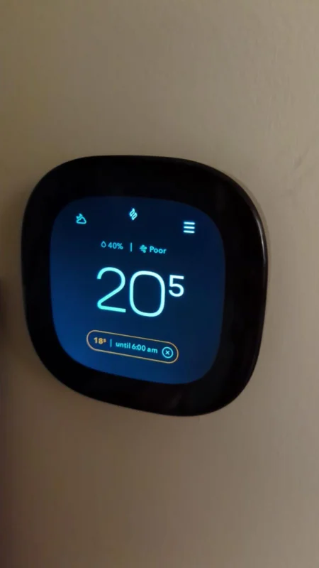 Smart thermostat displaying indoor temperature