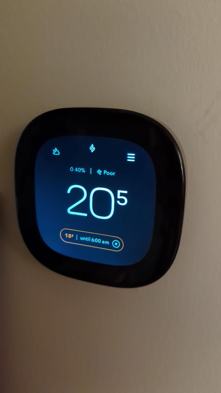 Smart thermostat displaying indoor temperature