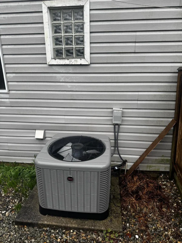 Outdoor air-conditioning condenser beside a house