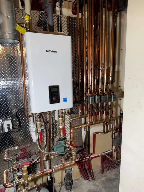 Tankless water heater with hydronic piping manifold