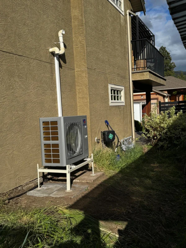 Outdoor heat-pump condenser beside a home