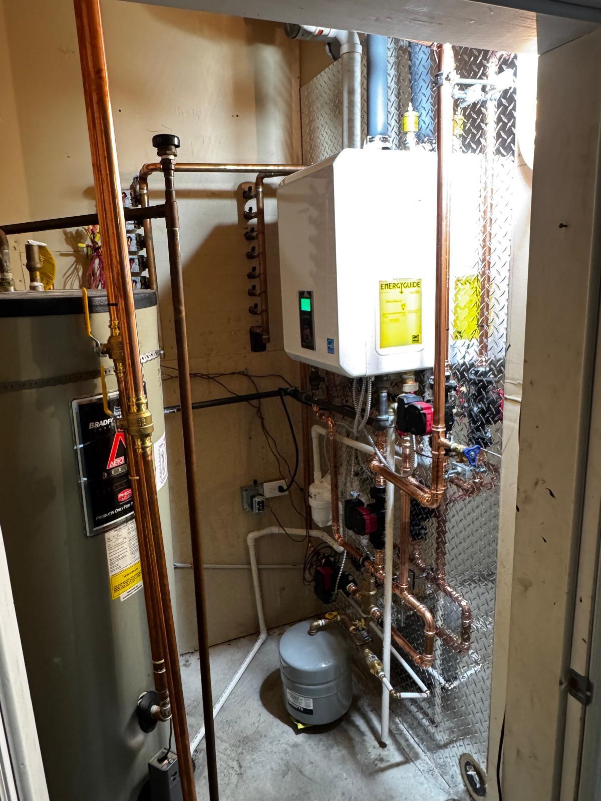 Tankless water heater and hydronic piping installation